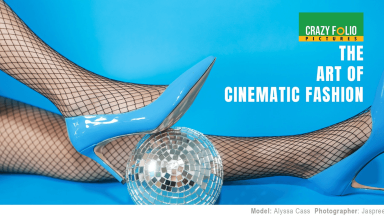 A pair of blue high heels on fishnet stockings next to a disco ball