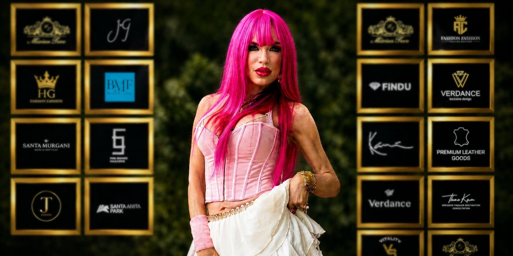 A woman with vibrant pink hair poses confidently for a photo, embodying the spirit of music and healing.